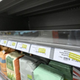 Empty grocery shelves with stickers that read "temporarily unavailable"